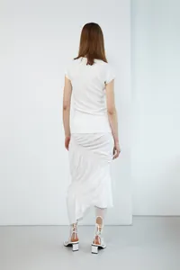 Rear view of white fishtail skirt showing high waist asymmetrical side tie and ruffle hem