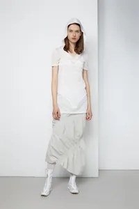 Detail of high-waisted grey striped pleated skirt and white hooded sheer mesh top