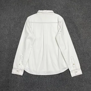 Detail of white cotton shirt back with contrast brown stitching and box pleat design
