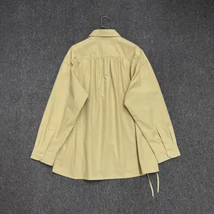 Detail view of khaki cotton shirt back featuring rich pleats and adjustable drawstring hem
