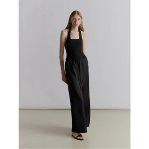 Women's black halter neck slim top and wide-leg trousers set in minimalist chic style