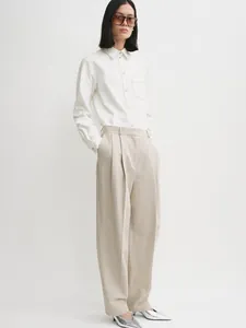 Minimalist long sleeve white shirt and beige wide-leg trousers for professional chic look
