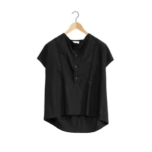 Minimalist black short sleeve cotton blouse with loose fit and unique asymmetric hemline