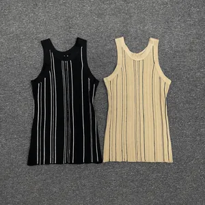 Close-up of ribbed knit sleeveless vests in black and beige with contrasting vertical stripes