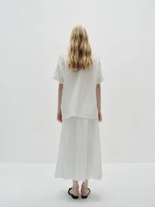 Rear view of women's loose white short sleeve T-shirt and long skirt set in soft cotton