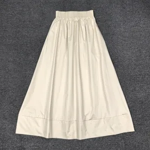 Detail of high waist elastic band and pleated texture on an A-line cotton midi skirt