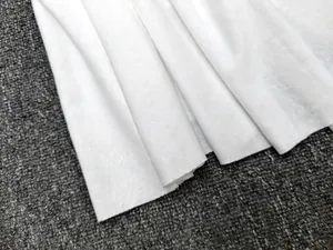 Close-up of premium white twill fabric detail showing thick texture and fine weaving