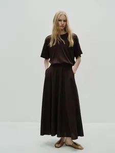Detail of cocoa brown two-piece set featuring short-sleeve T-shirt and high waist maxi skirt