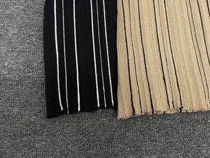 Detail of ribbed knit fabric texture in black and khaki striped patterns