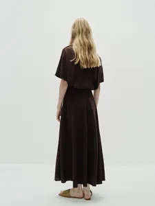 Detail of dark brown A-line skirt and T-shirt set with natural textured fabric drape