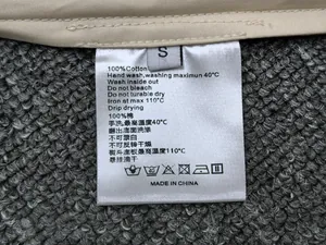 Detail of care label on a cotton skirt showing 100% cotton material and size S