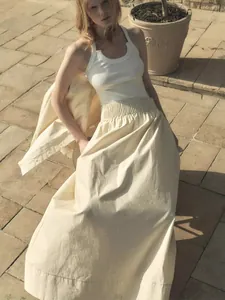 Women's white tank top and beige cotton A-line skirt set with elastic waist