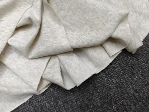 Detailed macro view of soft heather grey knit fabric showing texture and draping
