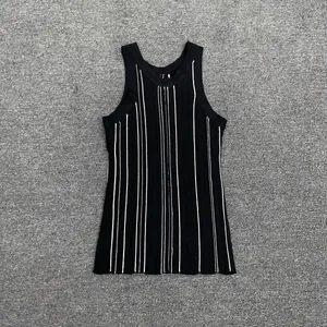 Detail of black rib-knit vest with white vertical stripes and slim fit texture