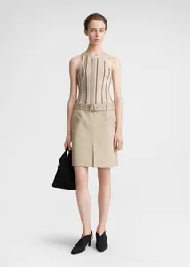 Detail of beige ribbed knit vest with black vertical stripes and matching utility skirt