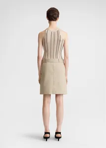 Rear view of striped ribbed knit halter top and beige A-line skirt with kitten heels