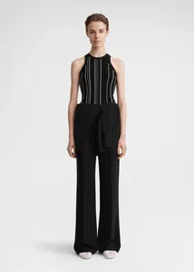 Vertical black and white striped ribbed knit tank top paired with wide-leg trousers