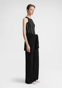 Detailed full-body view of a striped ribbed knit tank top with black wide-leg trousers