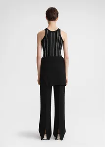 Detail view of the back showing striped ribbed knit tank top and slit hem trousers