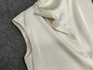 Close-up of the delicate satin fabric texture and premium stitching on this sleeveless top