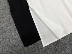Detail of premium cotton-blend fabric with reinforced side slit and precise stitching