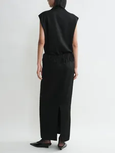 Detail view of a black sleeveless midi skirt featuring elegant waist fringe and a back slit