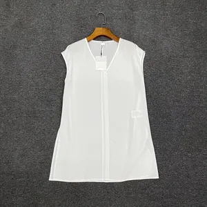 Detail of white V-neck sleeveless top showing lightweight fabric texture and side slit