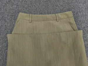 Detailed view of olive green high-waist skirt featuring belt loops and side pockets