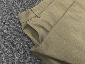 Detailed view of khaki high-waist A-line skirt featuring side pockets and fabric texture