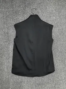 Detail of black satin sleeveless top featuring a sleek high neck and vertical back seam