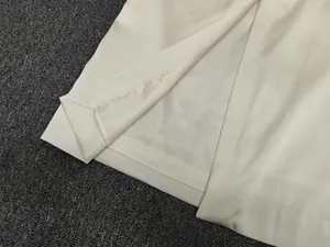 Close-up of cream satin skirt showing premium inner lining and delicate hem stitching