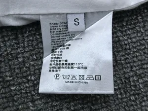 Macro view of wash care label and size tag for high waist A-line polyester skirt