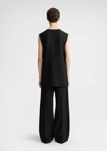 Rear view of minimalist black sleeveless tunic top and wide-leg trousers set
