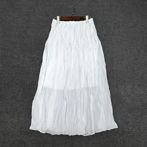 Detail of white pleated maxi skirt fabric texture and elastic waistband on hanger