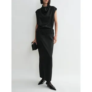 Elegant black sleeveless satin maxi dress with cowl neck and feather fringe waist detail