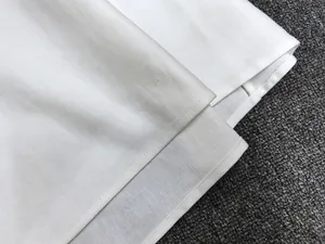Detailed macro view of white cotton-linen fabric texture with precise single-needle stitching