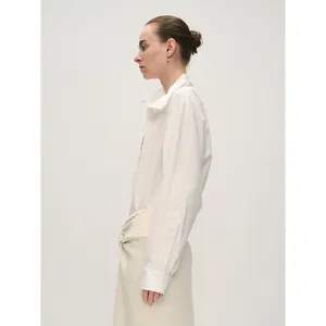 Women's minimalist white half-placket cotton shirt paired with beige twisted skirt