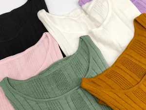 Detail shot of multi-color ribbed knit fabric textures showing vertical stripes and square neck