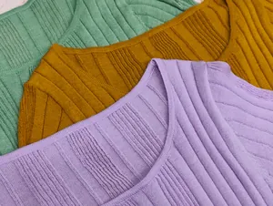 Macro shot of colorful ribbed knit tops showing fine vertical texture and soft U-neckline