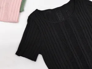 Detail of black ribbed knit short sleeve top showing crew neckline and textured fabric