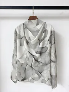 Close-up of lightweight white long-sleeved top with black abstract wave line patterns