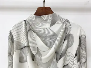 Detail of white hooded blouse with black abstract leaf print and lightweight silk fabric