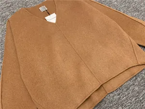 Detailed flat lay of camel V-neck wool blend sweater with loose fit and premium texture