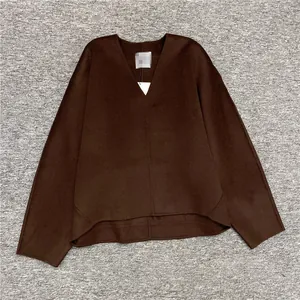 Flat lay of a dark brown V-neck loose wool sweater with oversized sleeves for winter