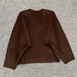Flat lay of a loose dark brown wool jacket with V-neckline and wide batwing sleeves