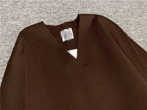 Detailed close-up of dark brown V-neck wool sweater featuring a soft brushed texture