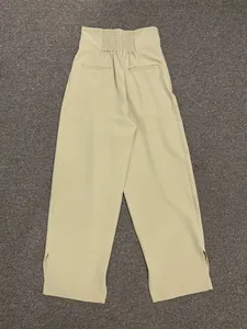 Detail of high waist wide leg pants showing elastic back waist and side slit leg cuffs