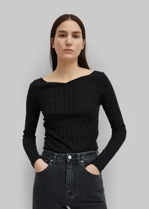 Close-up of black ribbed knit long sleeve top with elegant boat neck and slim fit texture