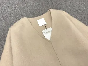 Detail of minimalist apricot V-neck double-faced wool top with premium fabric texture