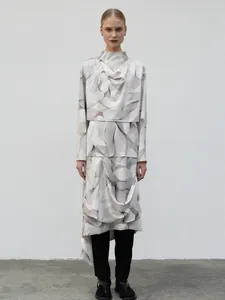 Detail of white draped long-sleeved top and skirt set with grey abstract wave pattern